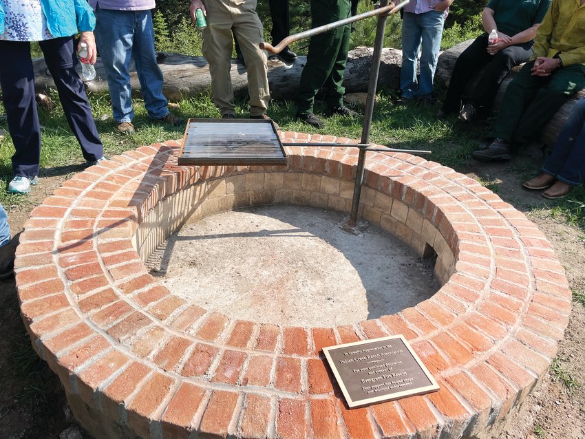 The fire pit ring has a plaque thanking the residents.