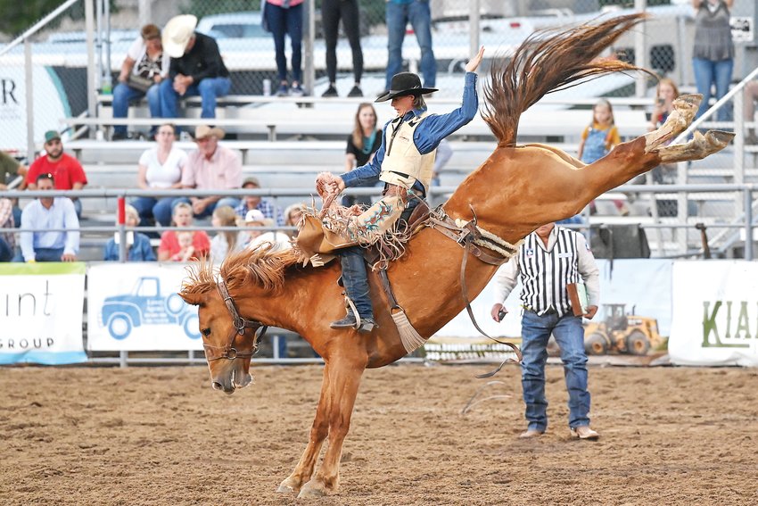 Garrett R. Uptain of Craig hangs on tight in the Saddle Bronc Riding event Aug. 6 at the Douglas County Fair & Rodeo.