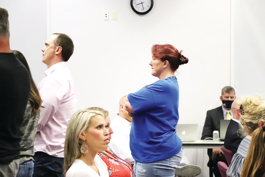 People who attended the Aug. 24 Douglas County School Board meeting stood in support of comment they supported and faced the back of the room when they disagreed with public comment.