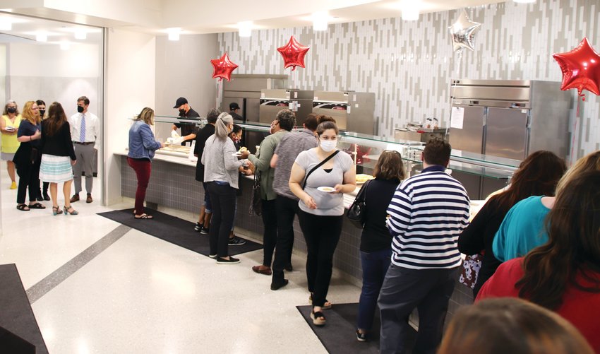 Workers line up to sample the fare provided by employees at the Mountain View Cafe, located on the third floor of Adams County's Human Services building at 11860 Pecos St. in Westminster.