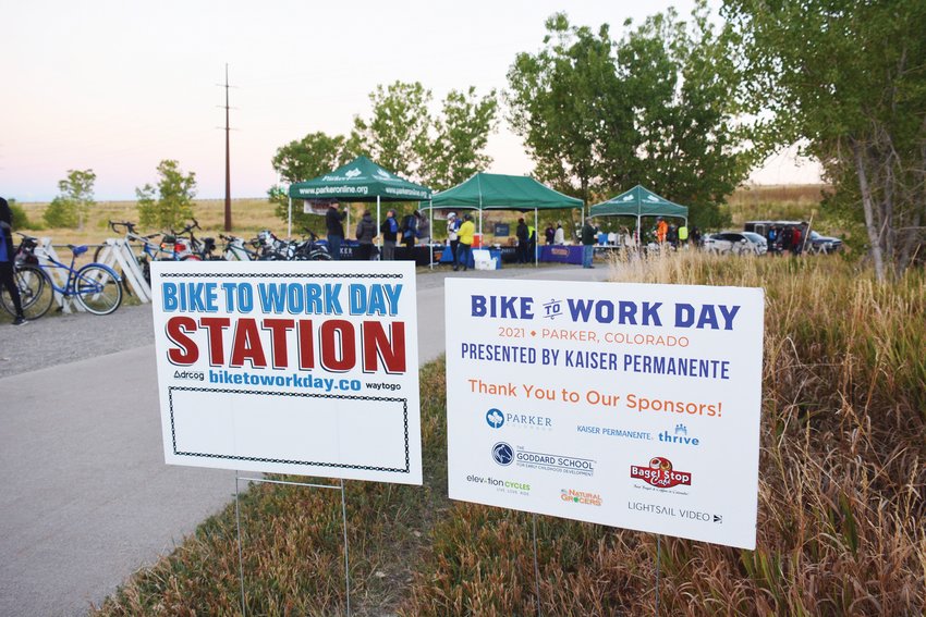 Signs marked the spot on the Cherry Creek Trail for cyclists to stop to get T-shirts and breakfast items during the Parker Bike to Work Day Sept. 22.