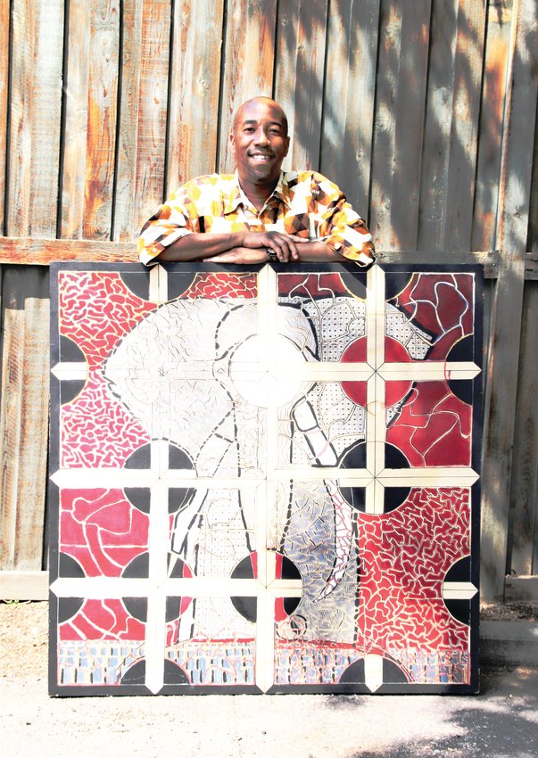 Warren Stokes of Denver’s Washington Park neighborhood stands with one of his maze art pieces called "Ivory vs Enamel." Stokes uses his art as a healing mechanism, in his profession as a teacher and for activism.