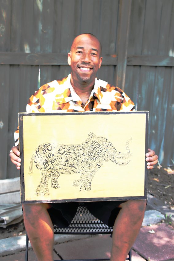 Warren Stokes of Denver’s Washington Park neighborhood holds up one of his mazes titled “Dukellington Elephant.” Stokes, an artrepreneur/mazeologist, has created about 1,300 mazes to date.