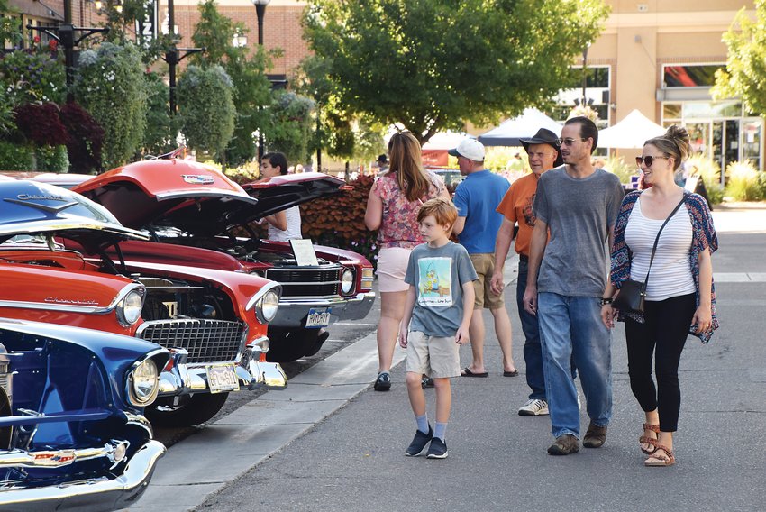 Passersby in the crowd look at classic cars on display as part of the car show during the City of Centennial's Sept. 18 celebration.