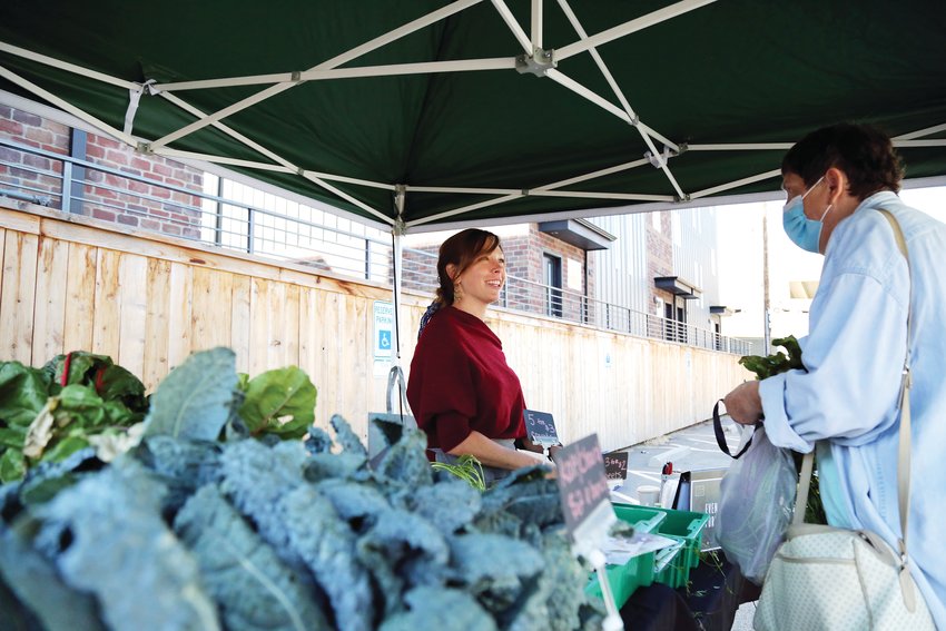 Sydney Miller, of Grow + Gather, sells locally grown produce at the Englewood Market held Oct. 2.