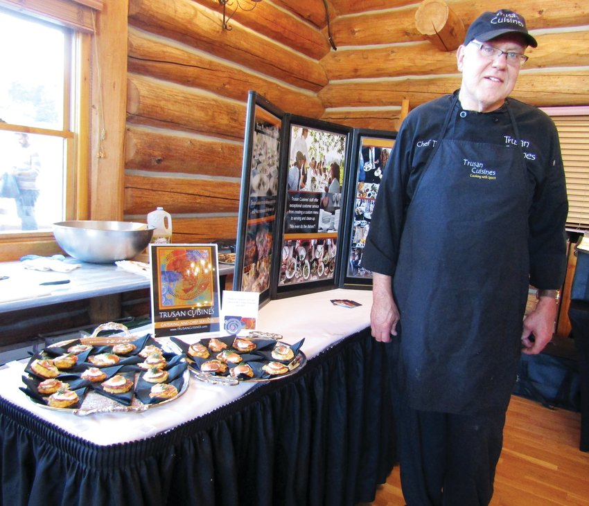 Trusan Comstock with Trusan Cuisines catering service displays smoked salmon on corn cakes before Taste of Evergreen began.