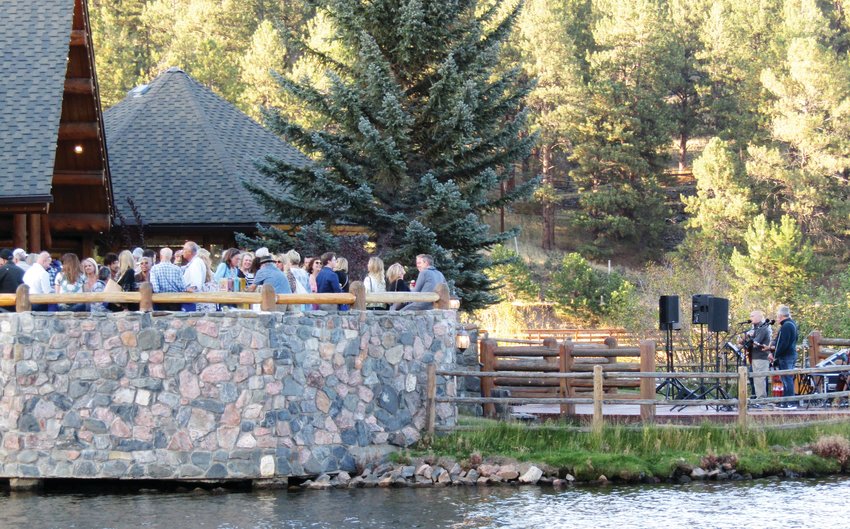 Before the doors opened, Taste of Evergreen attendees mill around outside the Evergreen Lake House while Somebody’s Brother performs.