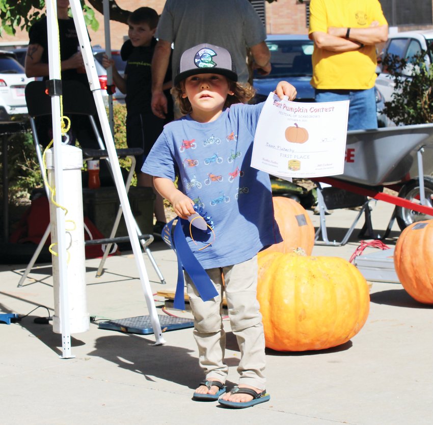 Eziah Fluharty with his winning pumpkin.