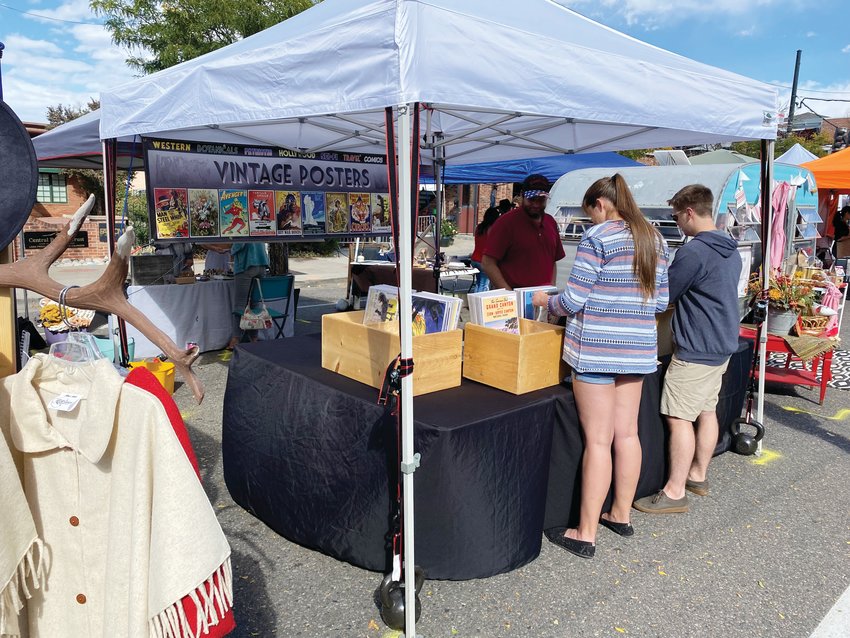 Shoppers paused to sort through bins of vintage posters at a stand at “Second Saturdays” on Main Street in Littleton on Oct. 9.