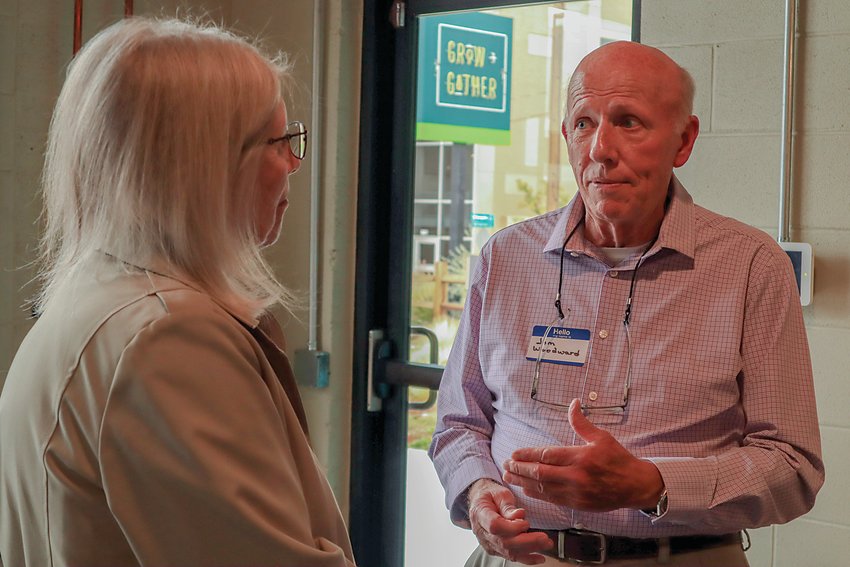 Carol Willis, left, president of the Greater Englewood Chamber of Commerce, speaks with former Englewood Mayor Jim Woodward during a candidate meet and greet on Oct. 14.