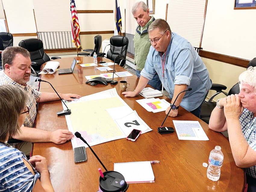 Leaders from the Elbert County Department of Elections meet with the commissioners to present possible redistricting maps. Elbert County Clerk &amp; Reporter Dallas Schroeder, top left; Rhonda Braun, elections manager, bottom left; Elbert County Commissioners Grant Thayer, Chris Richardson, and Rick Pettitt, top to bottom at right.
