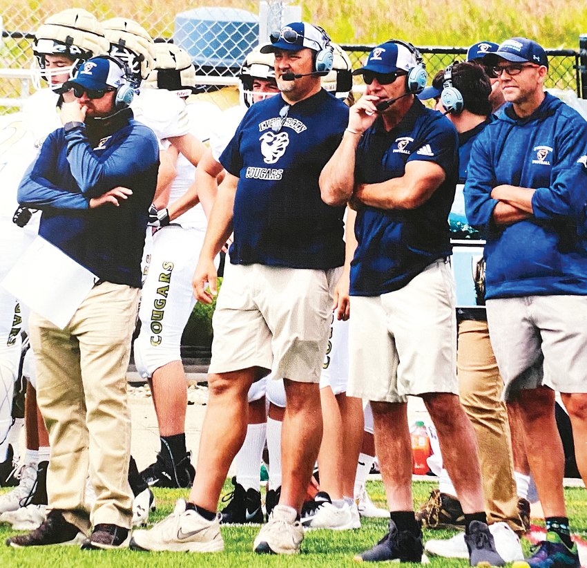 From left, Evergreen head coach Matt Van Praag and assistant coaches Tom Poholsky, Matt Callison and Scott Woodward at a game in 2019.