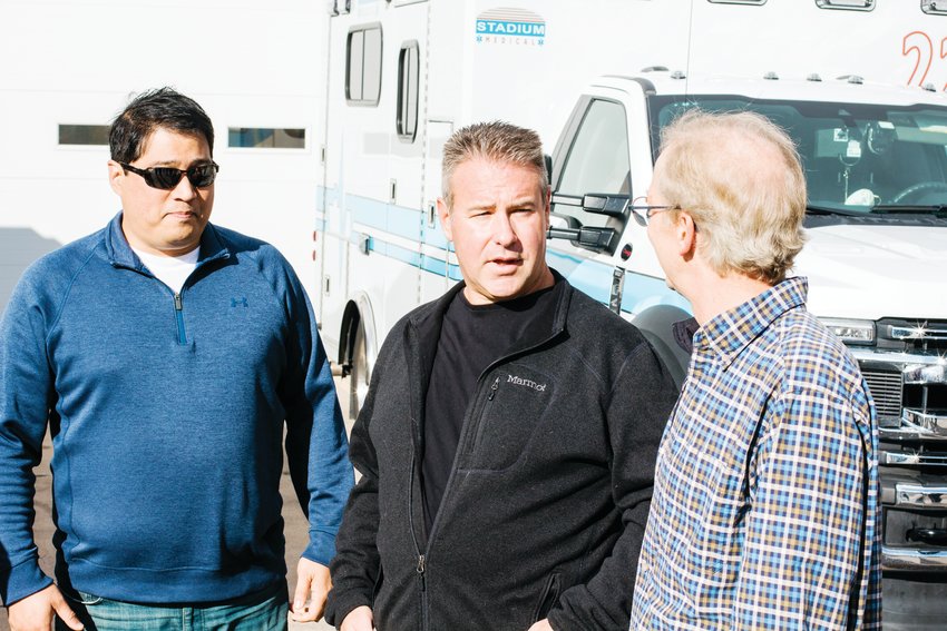 Demetrios Fefes, center, chats with Paul Mueller, left, and Dr. Brian Beezley, who performed CPR on him until first responders arrived, after he suffered cardiac arrest at the Colorado State Patrol Track in August.