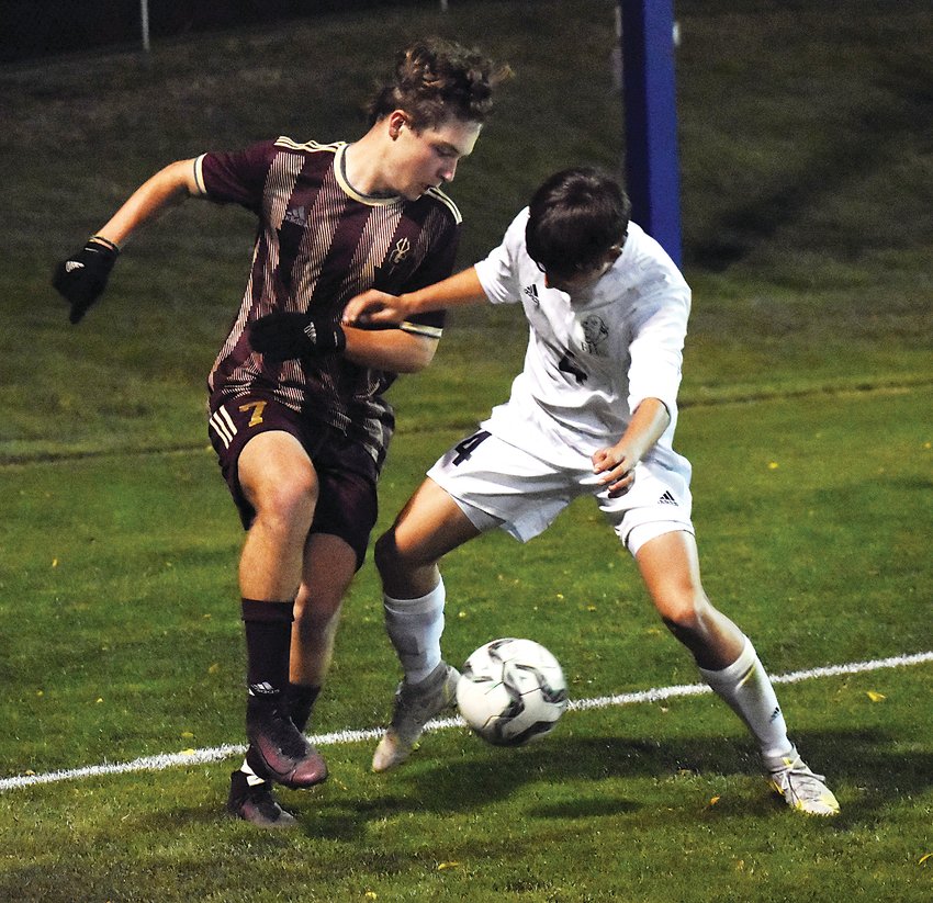 Golden junior Andrews Garfias (11) and Evergreen freshman Nico Seaman (4) battle for control of the ball near the end-line during the Class 4A Jeffco League game Oct. 18 at the North Area Athletic Complex. The Demons and Cougars ended in a 1-1 tie.