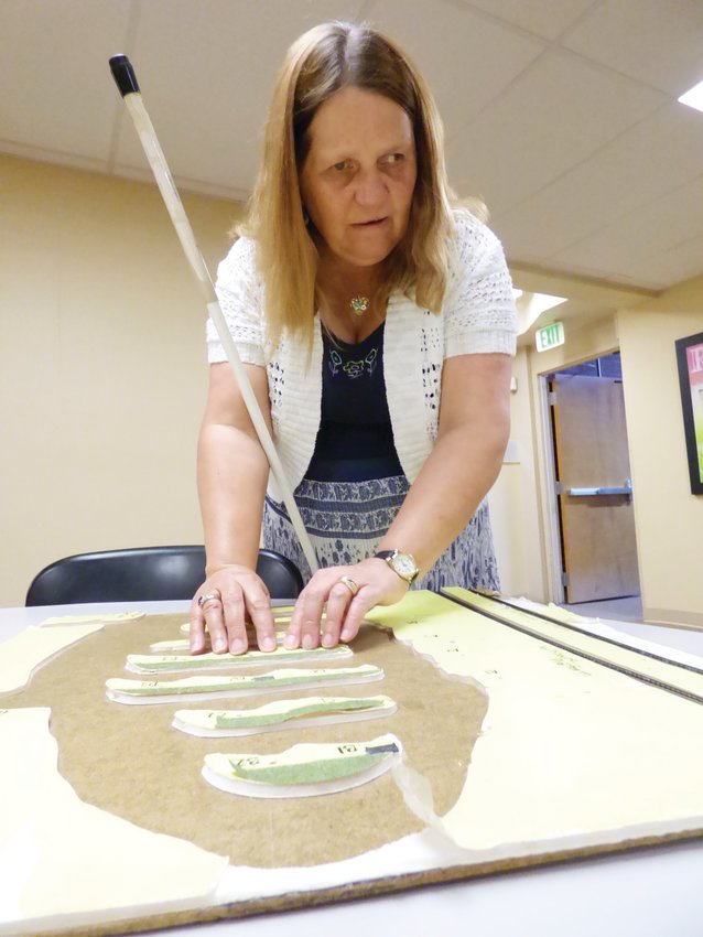 In a 2017 file photo, Colorado Center for the Blind director Julie Deden demonstrates how blind people study models of nearby transit stations.