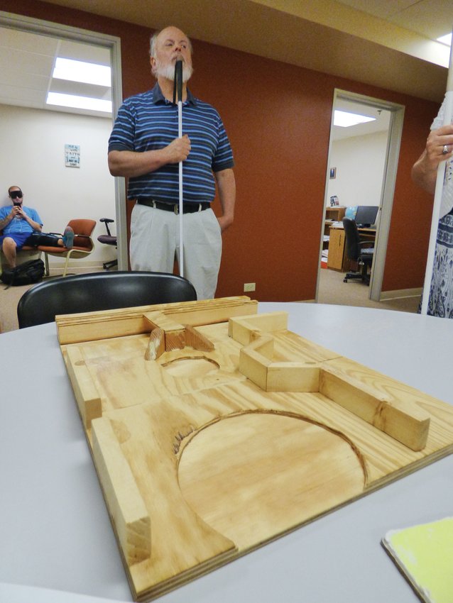 In a 2017 file photo, Colorado Center for the Blind spokesman Dan Burke stands behind a model of the Englewood light rail station.