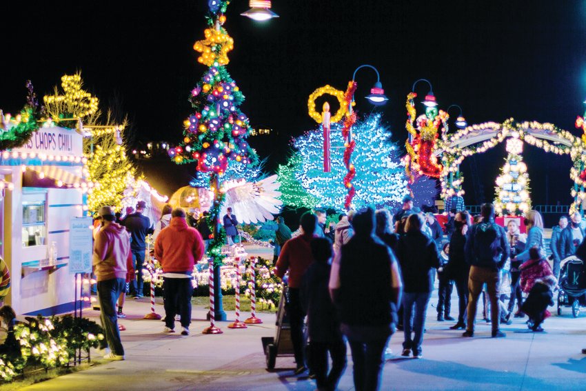 Visitors stroll among holiday lights at Camp Christmas.