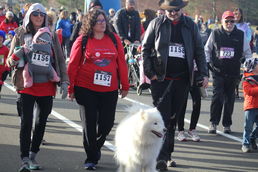 It's a family affair among this batch of walkers at Brighton's Turkey Trot Nov. 20. From left, Jessica Tribett, Kate Tribett and Mitchell Tribett and their pet take the first few steps of the 5K walk. Kate finished in a time of 1:03.53. Jessica finished in a time of 1:04.07, and Mitchell finished in a time of 1:04.10.