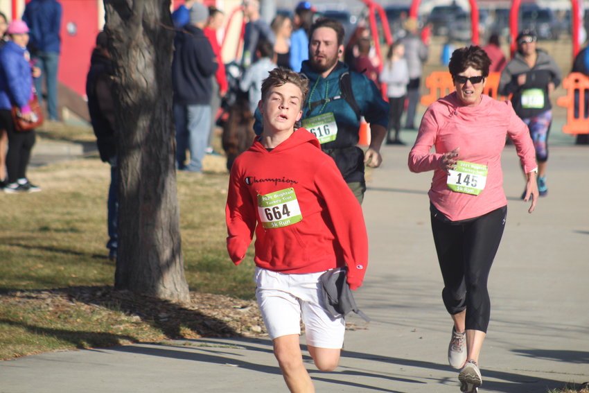 Ashton Lanford hits the finish line at this year's Brighton Turkey Trot with a time of 28:02. Laura Golembieski finished two seconds behind Lanford.