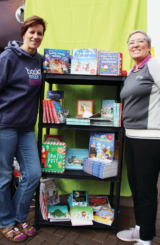 Beth York of Aurora and Brenda Luksch of Boulder, who are independent consultants with Usborne Books & More, which is an independent book publisher, stand with a display of books at the Cherry Creek Holiday Market on Nov. 18. The two carry about 2,000 titles for newborns to young adults.