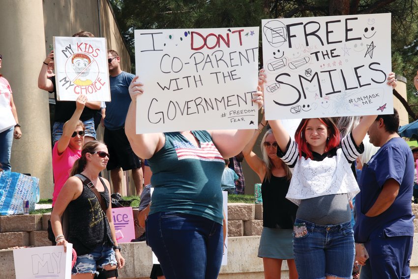 A sign read, "I don't co-parent with the government" during an Aug. 30 protest against mask requirements at the Arapahoe County administration building in Littleton.