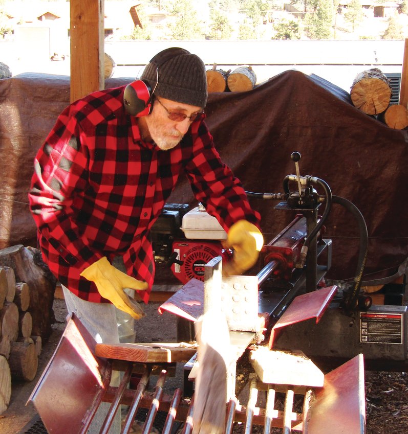 Jay Tierney operates the log splitter.