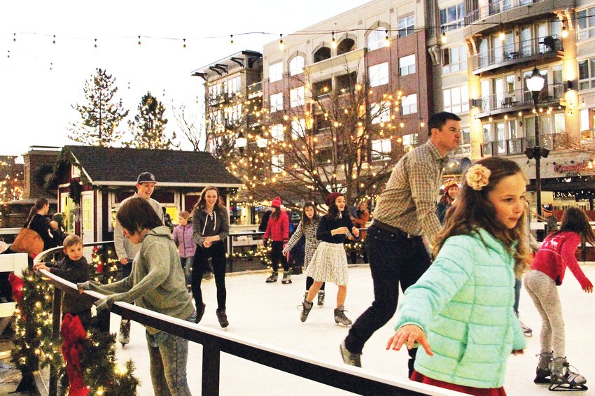 In a 2019 photo, families and friends go for a spin at the seasonal ice-skating rink at The Streets at SouthGlenn in Centennial.