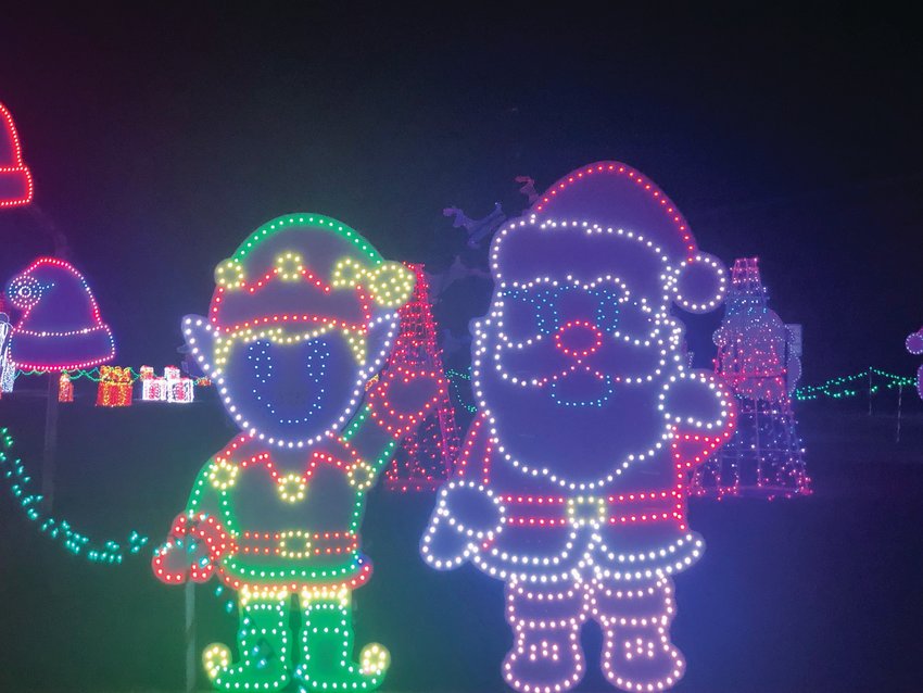 Santa and an elf light up the night at Bandimere Speedway’s Christmas in Color event on Thursday, Dec. 9.