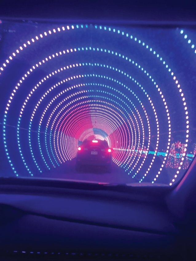 Cars drive through tunnels of lights that dance to music tuned to your car radio.
