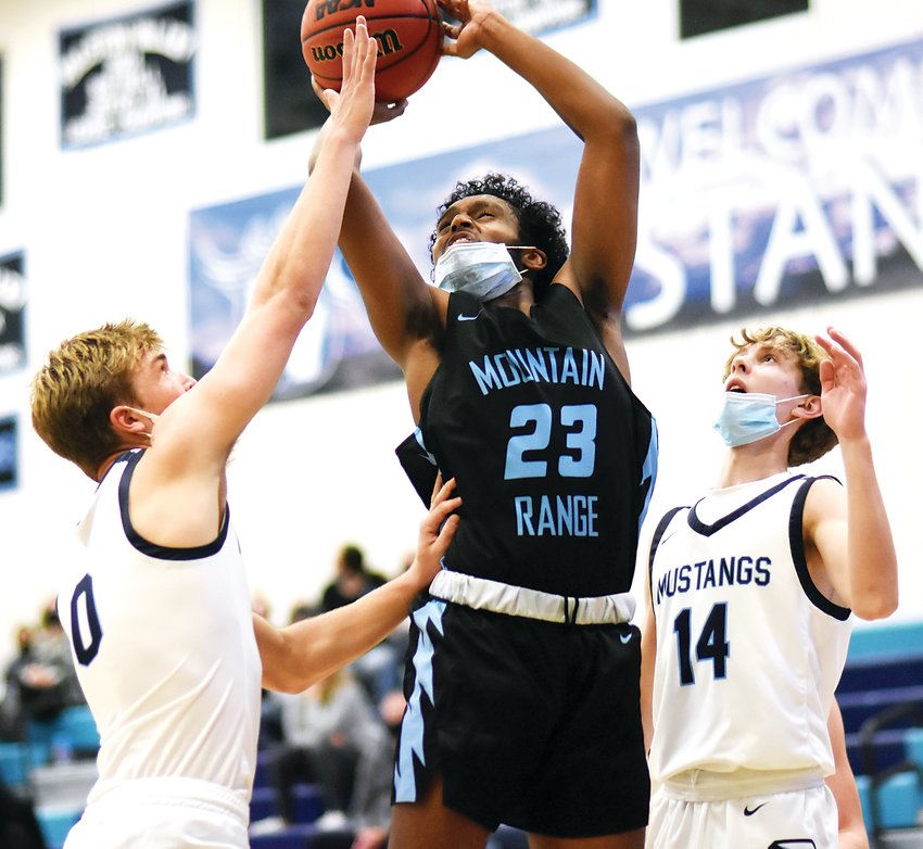 Mountain Range senior Fnan Yonas, 23, goes up for a shot between Ralston Valley senior Zach Friedman, 0, and sophomore Mason Trebilcock, 14, during the semifinal of the Ralston Roundup Tournament on Dec. 16 at Ralston Valley High School. The home team Mustangs won 78-41.