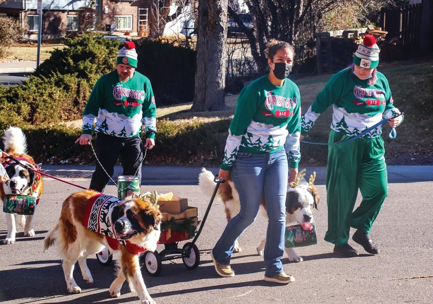 A procession of furry friends greets a Littleton resident with barrels of beer on  Dec. 16.