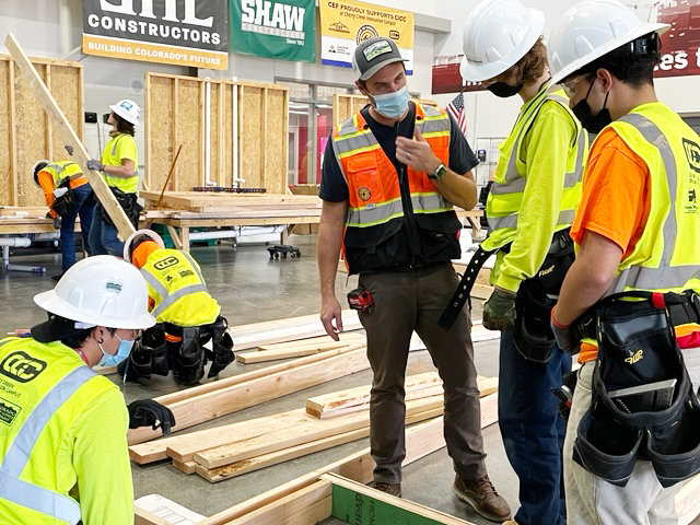Cherry Creek Innovation Campus students, with an instructor in the center, work on constructing tiny homes on Dec. 9.