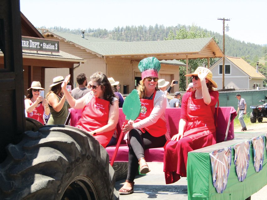 Christine Kleinbeck of Conifer, center, wears her crown and holds the rhubarb scepter during the Pine Grove Rhubarb Festival parade in June. Kleinbeck won first place in the rhubarb bake-off. She is flanked by second-place winner Cindy Busch, left, and third-place winner Sara Narum.