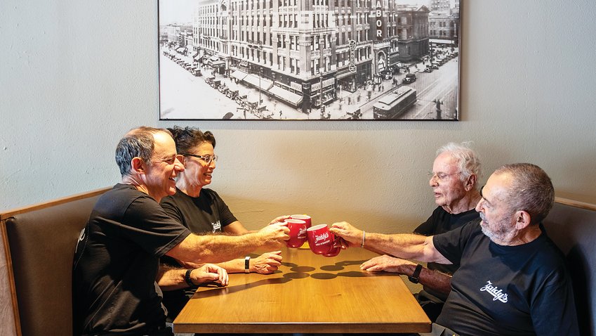 The new owners and original founder of Zaidy’s Deli &amp; Bakery raise a toast last August to the reopening of the restaurant in its new location at 600 S. Holly St. in Denver’s Washington Virginia Vale neighborhood. Pictured, from left clockwise, are co-owners and business partners Joel Appel, Beth Ginsberg and Max Appel; and Gerard Rudofsky, Zaidy’s founder and original owner.