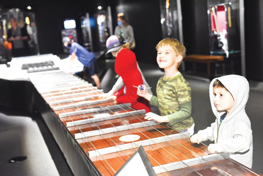 Some youth interact with the world's largest playable guitar ‚Äî which measures about 43 feet ‚Äî at the Denver Museum of Nature &amp; Science's exhibit, "Guitar: The Instrument That Rocked the World."