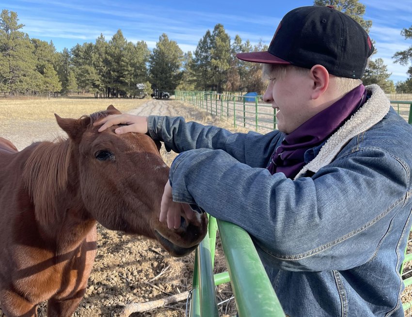 Brian Gillen stands with his family's 25-year-old horse, Thumper. Thumper was the horse Gillen rode from the days when he was a 12-year-old boy until his freshman year of college. Gillen is part of the West Texas A&M University Rodeo Team and hopes to become a professional rodeo cowboy.