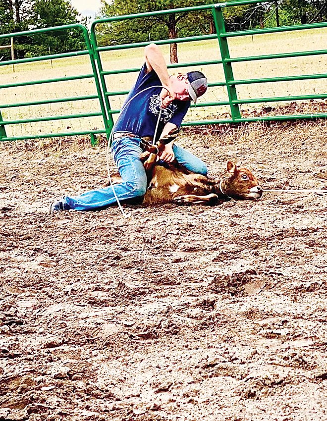 Brian Gillen ties down a calf, his rodeo specialty.