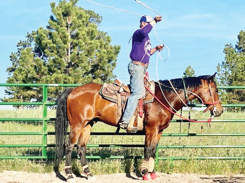 Brian Gillen stands atop his horse between practice runs.
