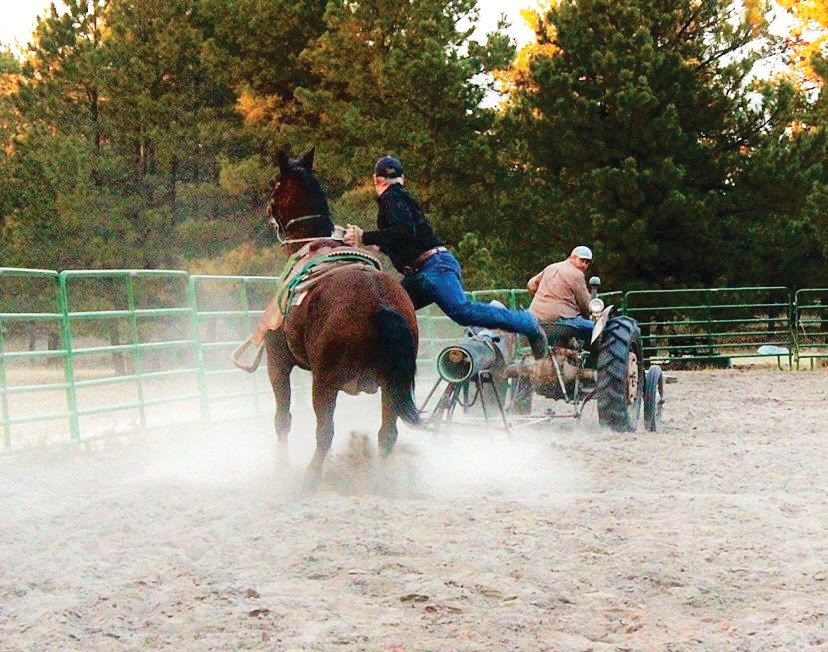 Brien Gillen and his father practice tie-down roping with a dummy on their family ranch.