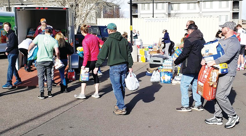Parker residents line up at Grace Baptist Church to donate hygiene items, water and pet food for a drive-in donation organized by resident Rob Nelson.