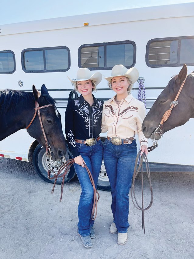 Hannah, left, and Josie Thomas pose with their horses at Casey Jones Park at the Elizabeth Stampede Rodeo royalty competition last September.