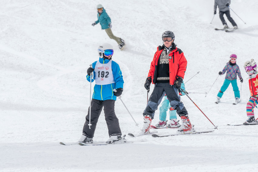 A Special Olympics Colorado athlete and coach on the slopes at the conclusion of the 2020 State Winter Games at Copper Mountain.