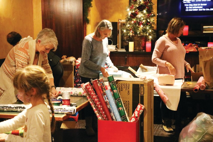 Volunteers of all ages came out to Tuscany Tavern in Evergreen to wrap gifts with the community.