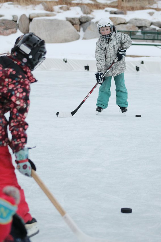 From left, Cora Campbell, 9, passes the puck to Tate Cowan, 9, during the Jan. 10 youth hockey skills camp at Georgetown’s Werlin Park. The camp, which the rec district is hosting two days a week through Feb. 16, teaches youth the hockey basics, including skating, puck control, and passing.