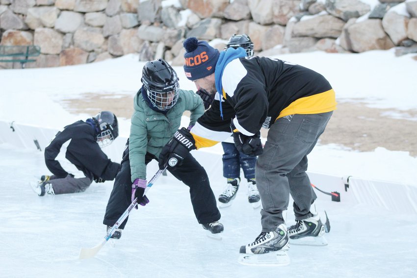 Instructor Jon Flenniken, right, shows Arwen Gibbons, 8, better handling technique during the Jan. 10 youth hockey skills camp at Georgetown’s Werlin Park. Flenniken will be leading the camp, hosted by the rec district, on Mondays and Wednesdays through Feb. 16.