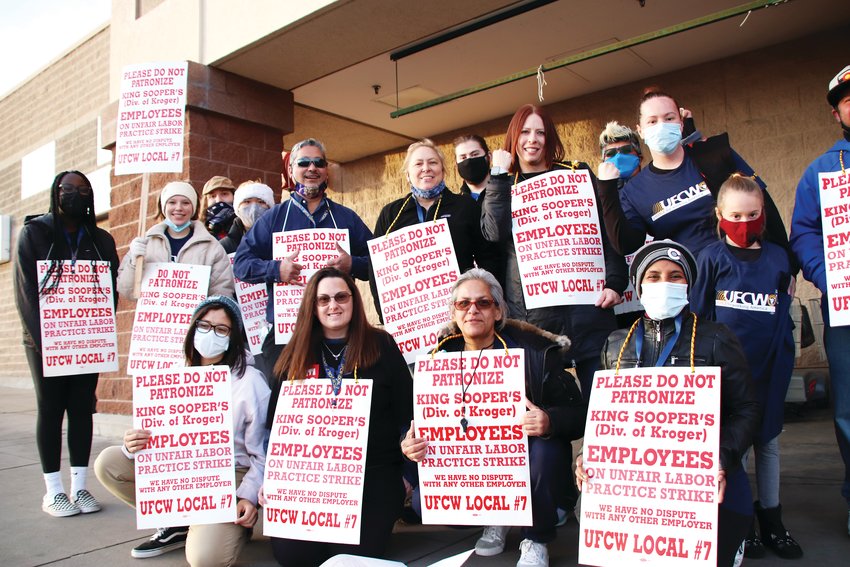 Workers on strike pose as a group in front of the King Soopers on Smoky Hill Road near Himalaya Street in east Centennial on Jan. 13.