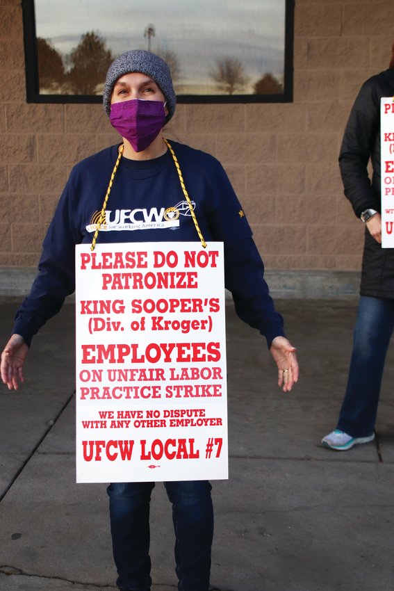 A worker at the King Soopers on Smoky Hill Road in east Centennial wears a sign in support of the union strike against the grocery store chain.