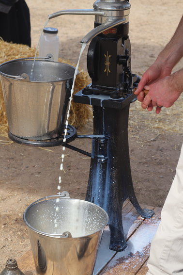 The heavier part of the raw milk gets pushed to the outside, creating skim milk, while the lighter part creates cream. The different consistencies are separated into buckets.