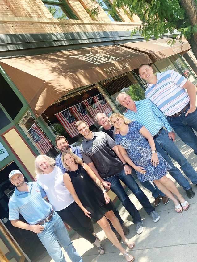 Dan May, second from right, Scott Cure, far right, and other La Vaca Cattle Co. employees stand before the company’s retail location in Littleton on June 11, 2021.