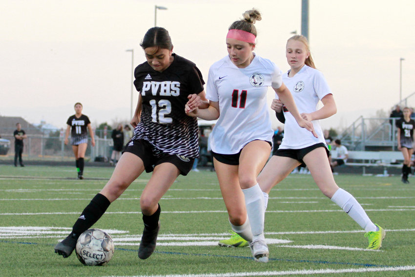 Bella Garbiso of Brighton, right, tries to steal the ball from Prairie View's Scarlet Lopez during their league match. The Bulldogs defeated the ThunderHawks 2-1 April 26.